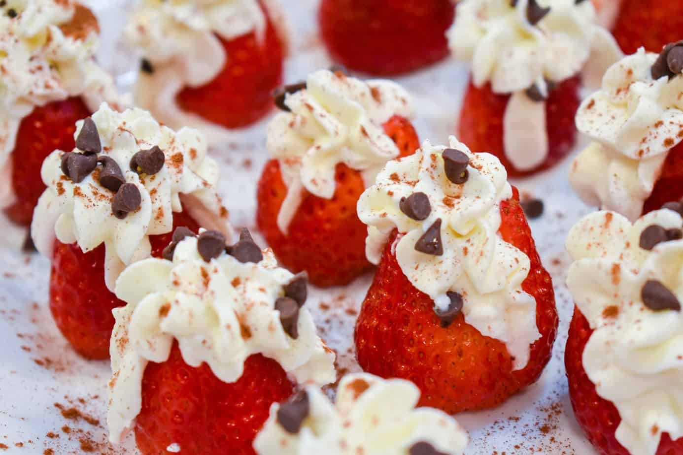 Lots of cannoli cream filled strawberries with mini chocolate chips.