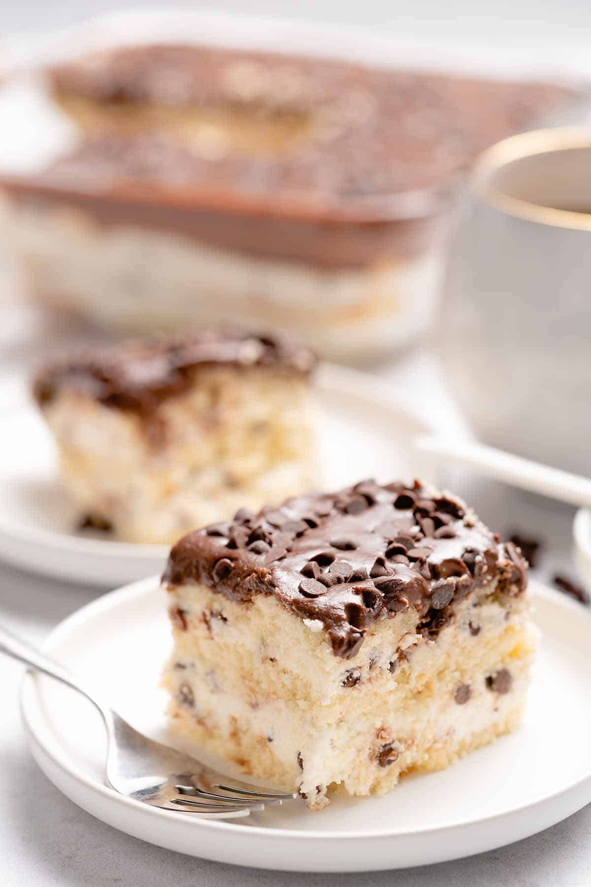 Slice of cannoli cake on a saucer.