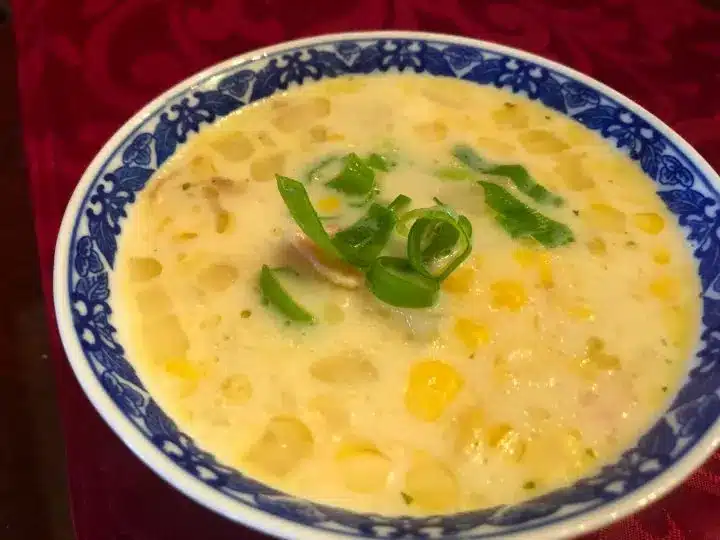 Corn chowder with potatoes in a fancy bowl.