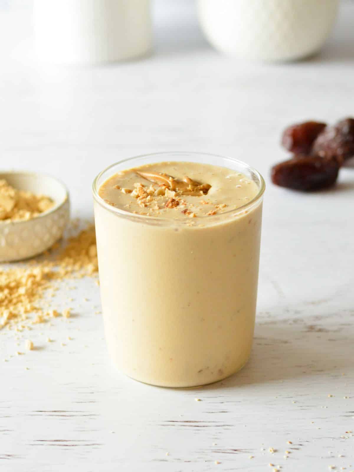 Serving of peanut butter smoothie in a glass.