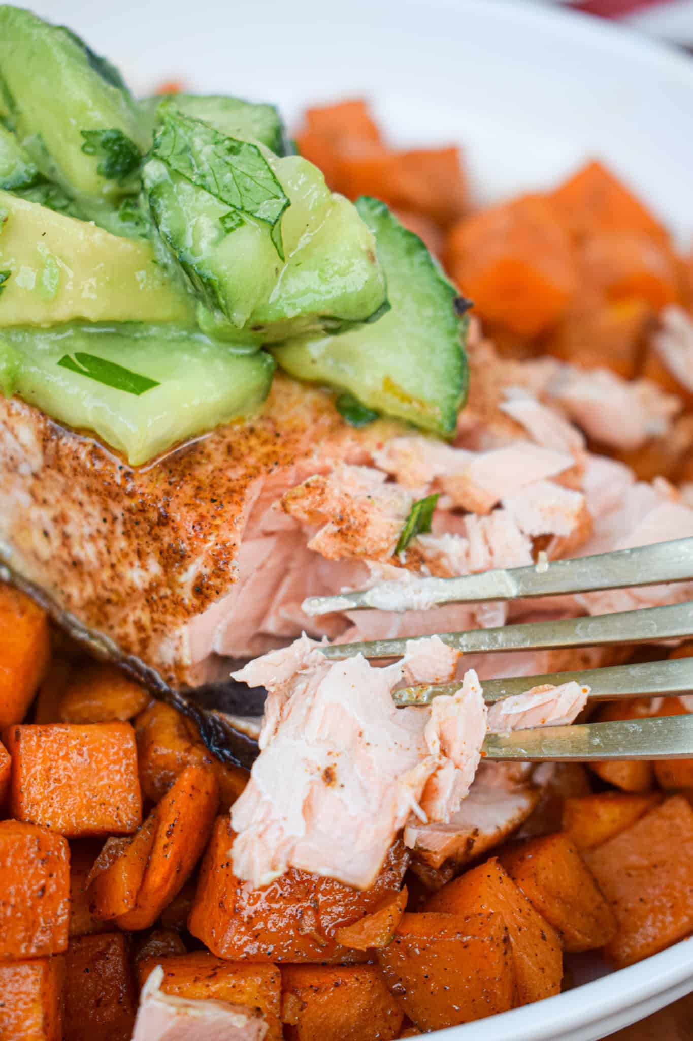 Chili lime salmon with Mexican spiced sweet potatoes with a fork.