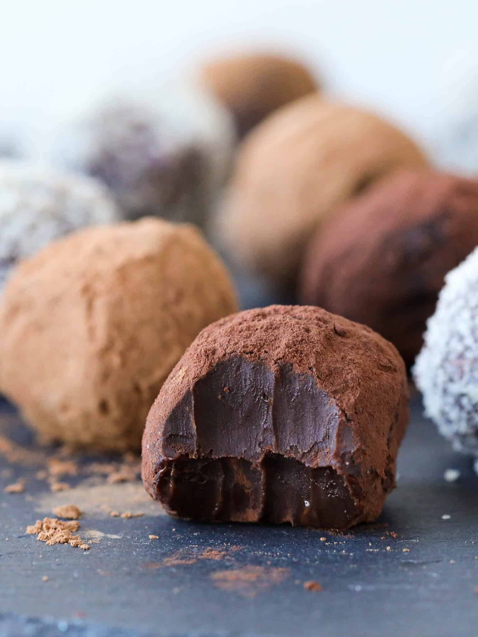 Chocolate truffles on a black slate board.