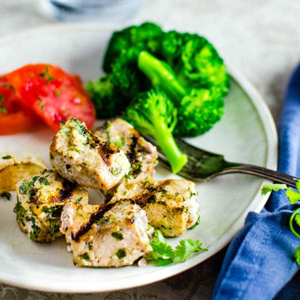 Swordfish and broccoli on a plate.