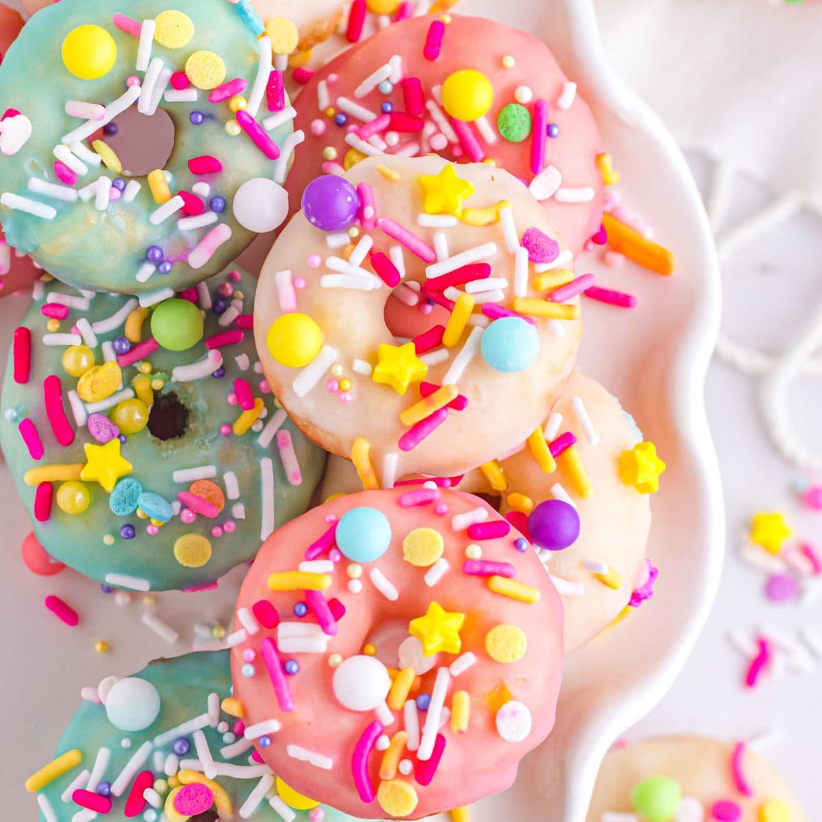 Stack of mini donuts on a cake stand.