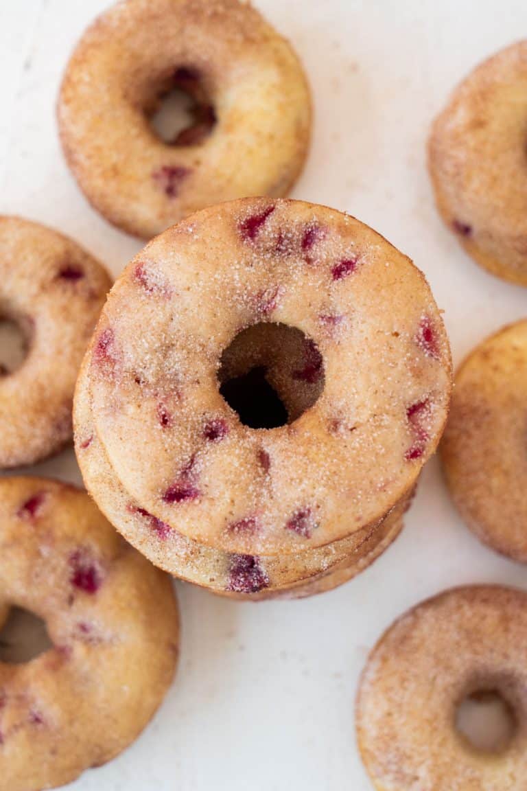 Stack of baked strawberry donuts.