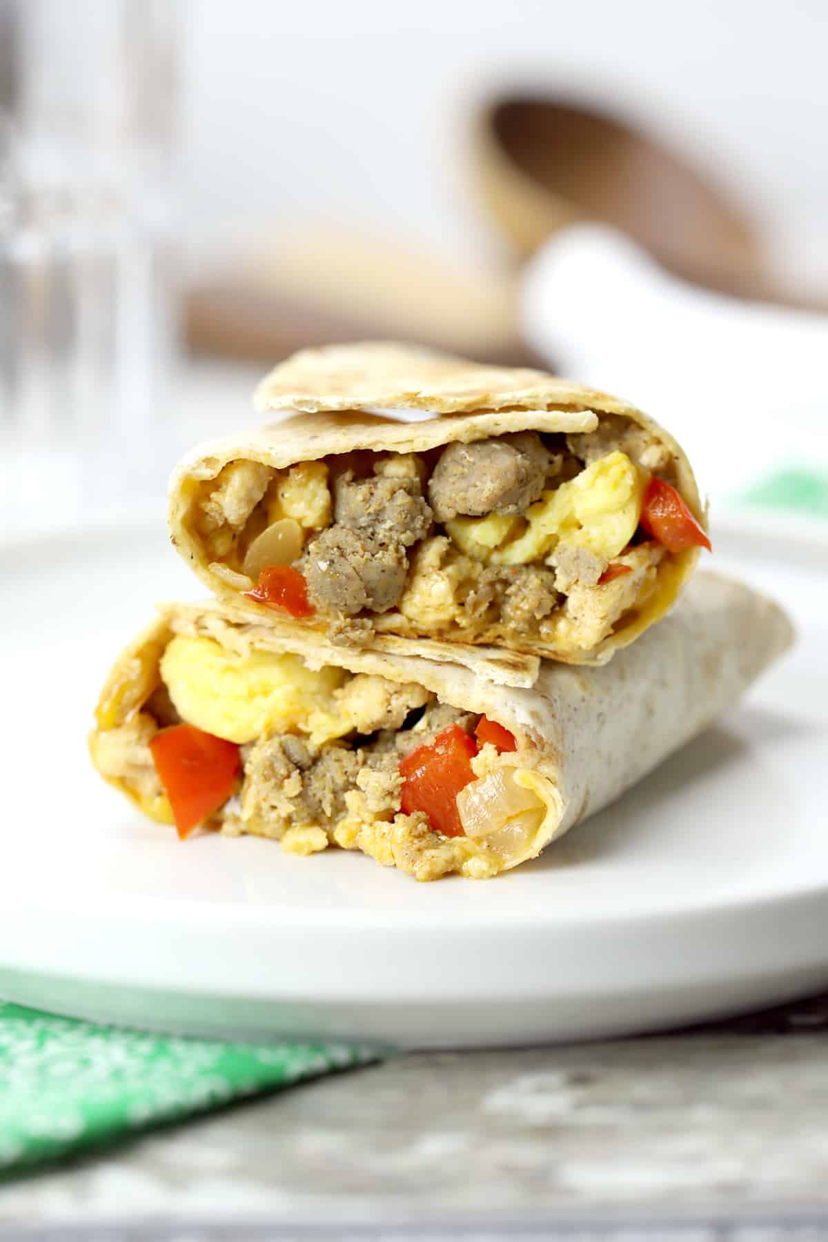 Breakfast burrito cut in half and stacked.