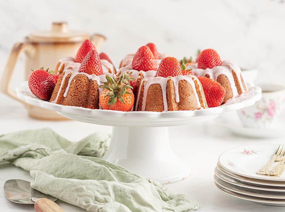 Strawberry mini bundt cakes on a cake stand.