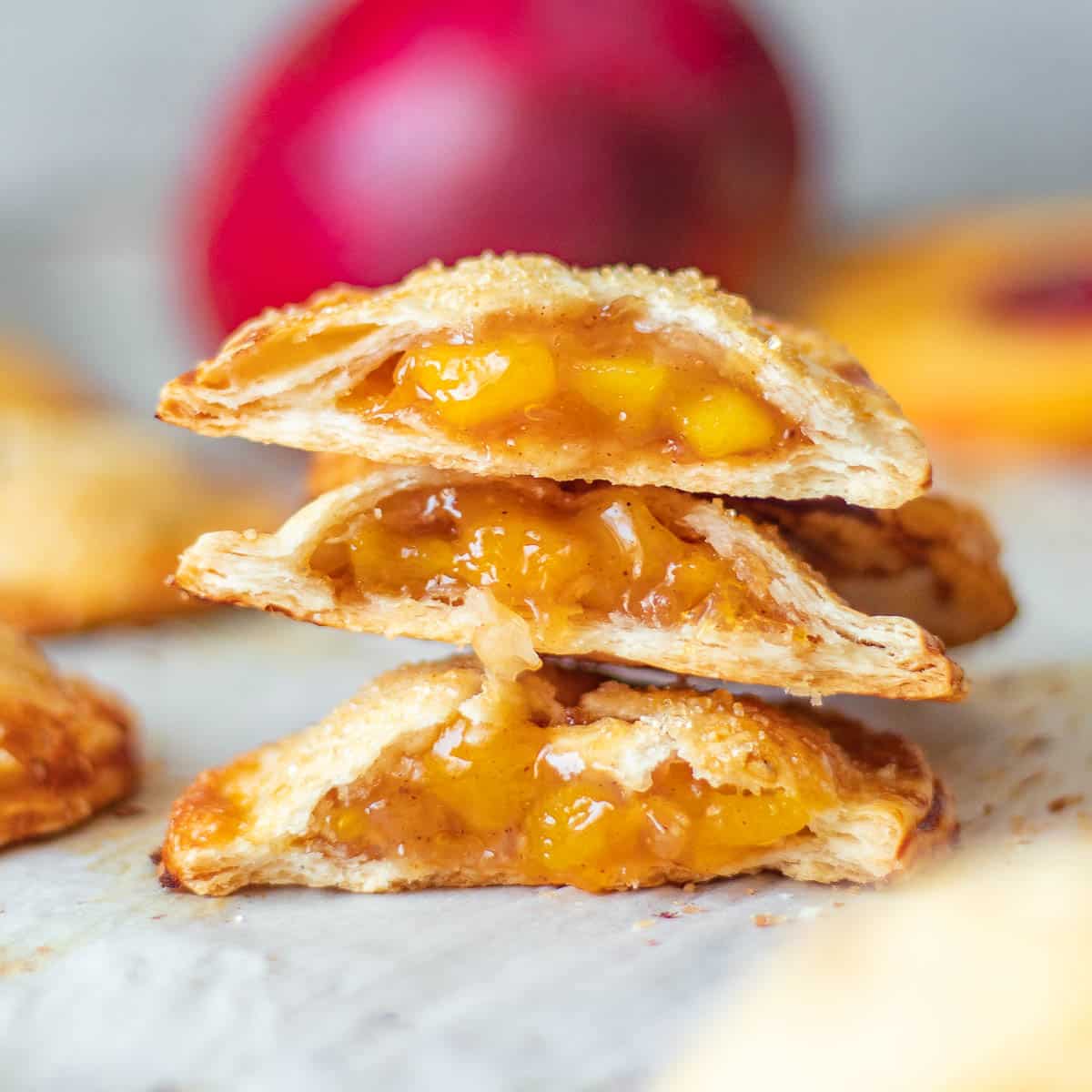 Stack of sliced in half peach mango pie