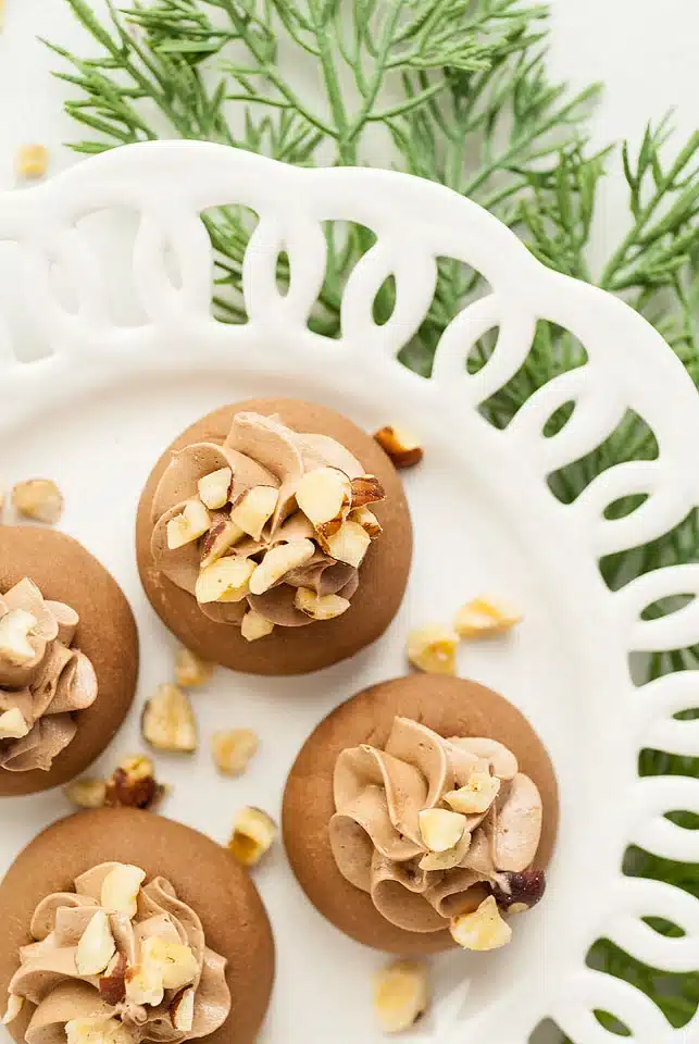 Nutellotti Italian cookies with chopped hazelnuts on a decorative white plate. 