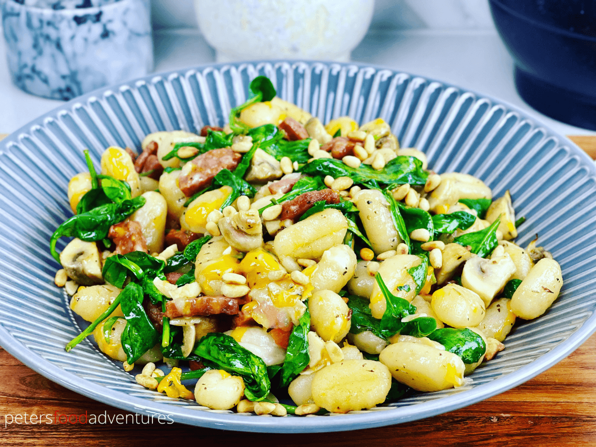 Sheet pan gnocchi in a decorative blue bowl.