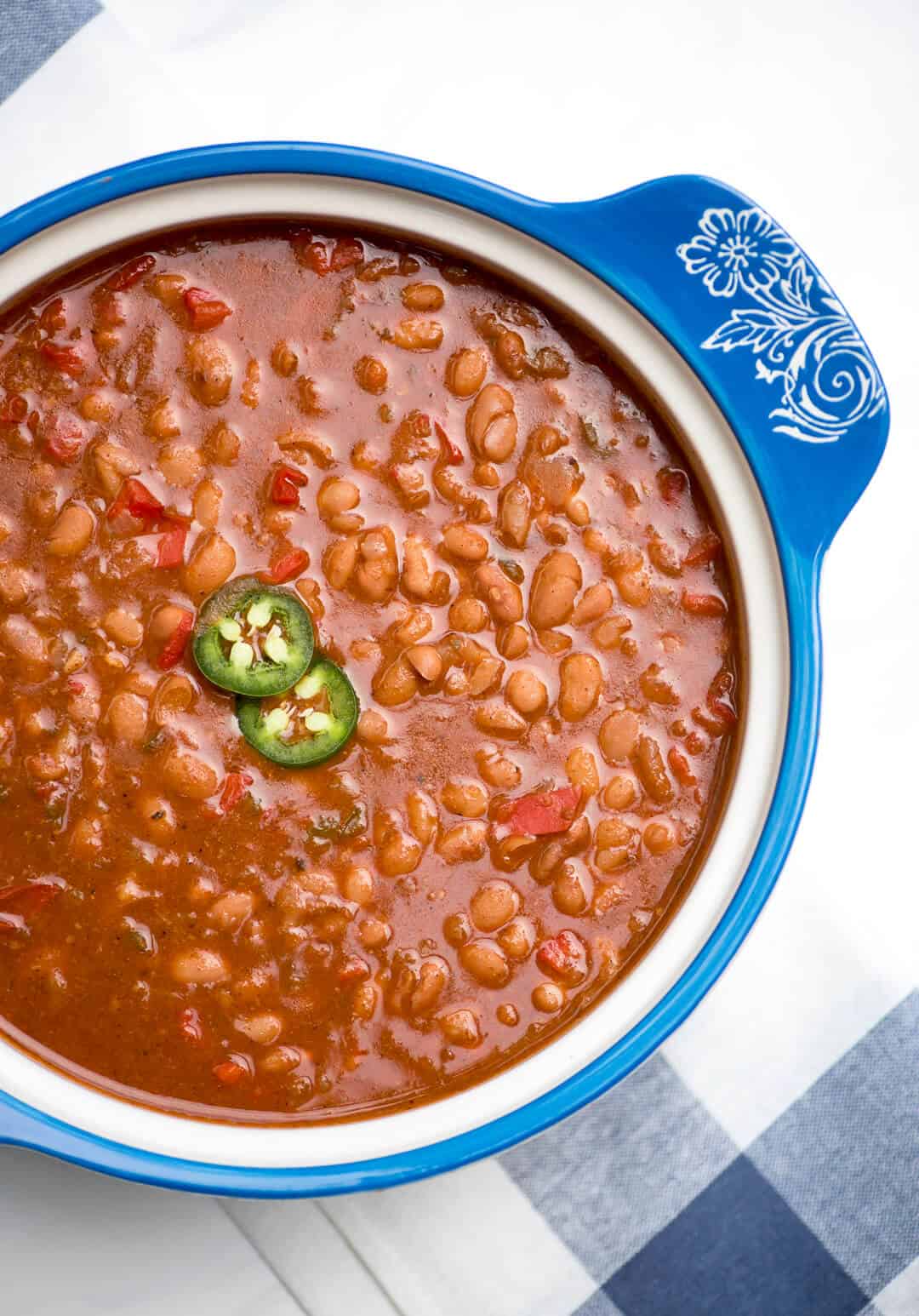 Mexican pinto beans in a decorative blue dish.