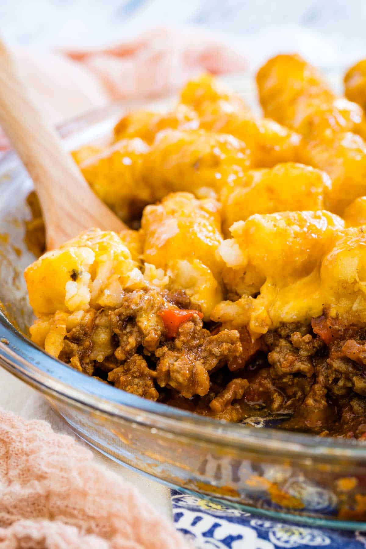 Spoon scooping out sloppy joe tater tot casserole.