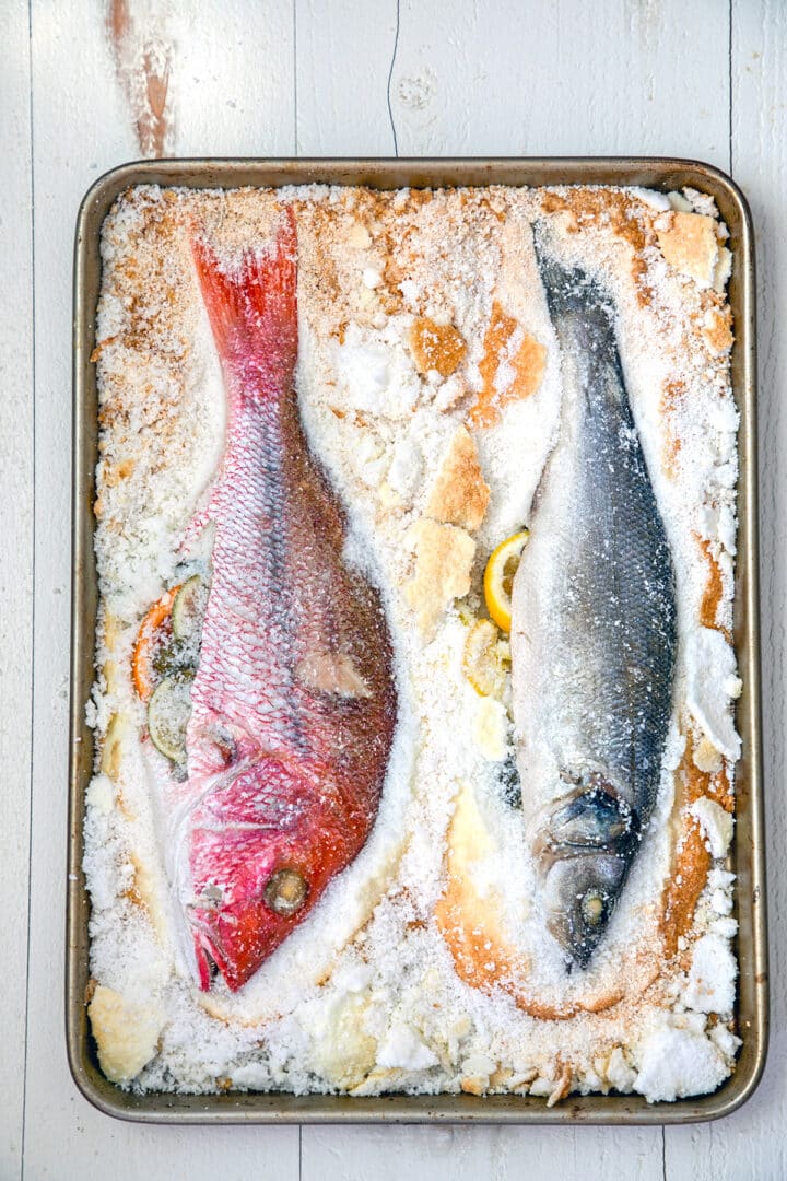 Salt baked fish in a baking pan.