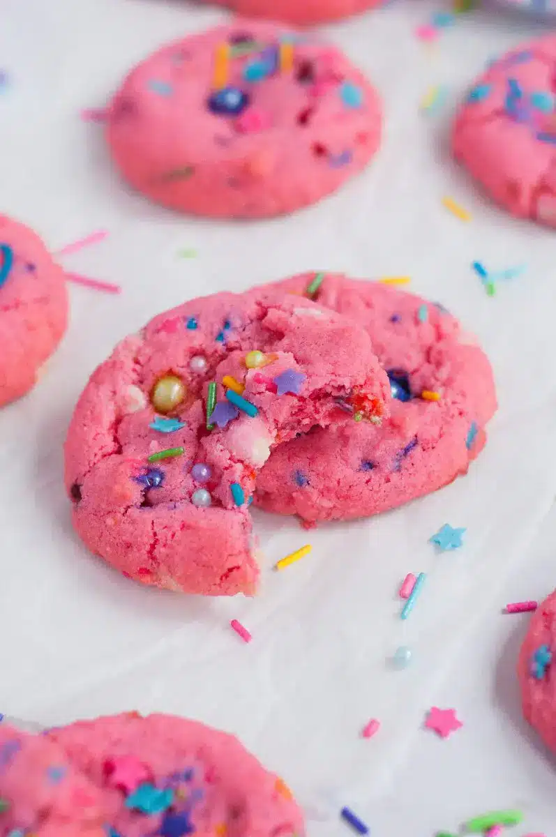 Pink strawberry almond sprinkle cookies with colorful sprinkles.