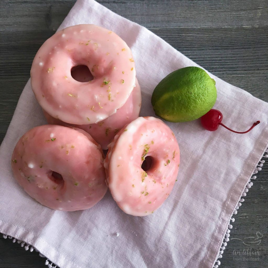 Stack of cherry limeade donuts on an elegant cloth