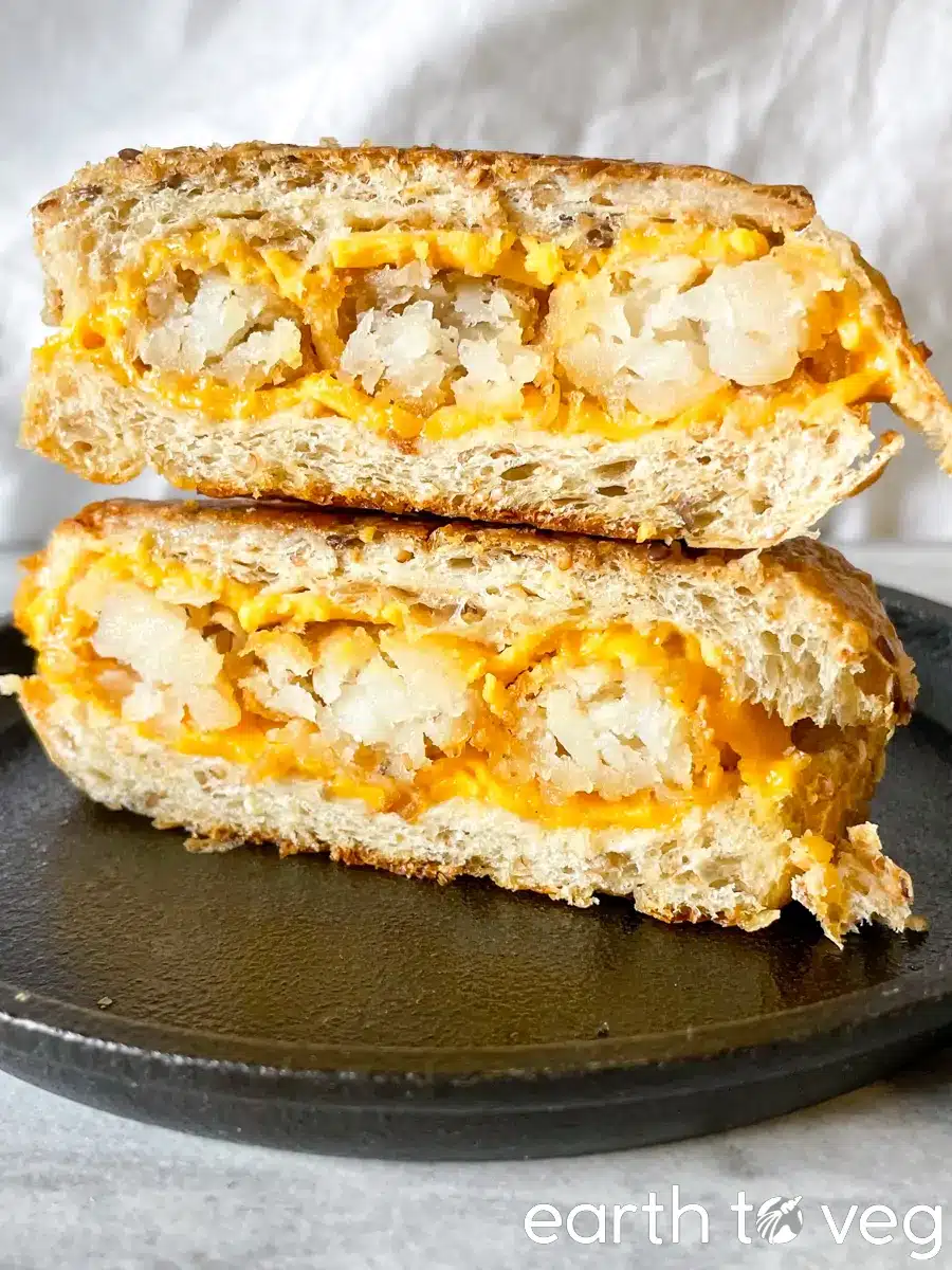 Tater tot grilled cheese melt, cut in half and stacked.