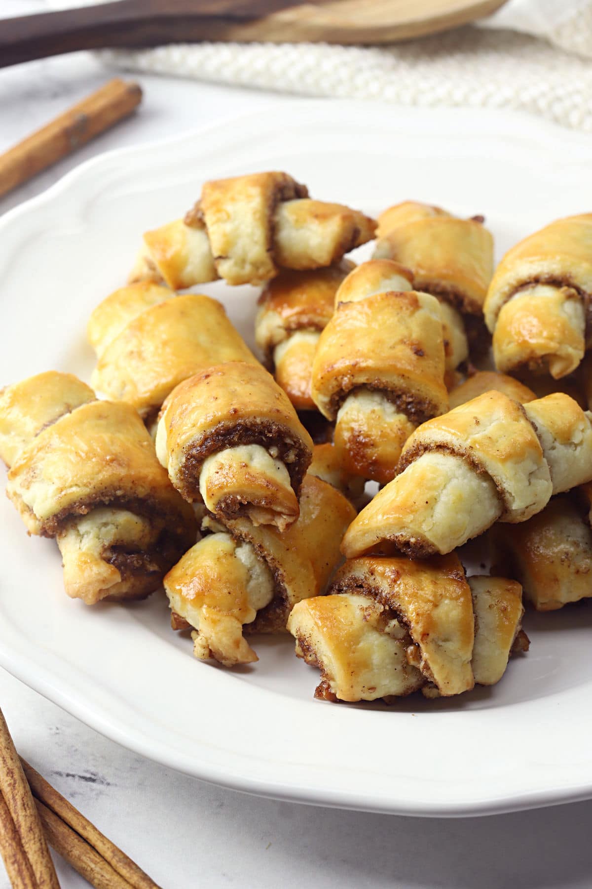 Cinnamon pecan rugelach on a white plate.