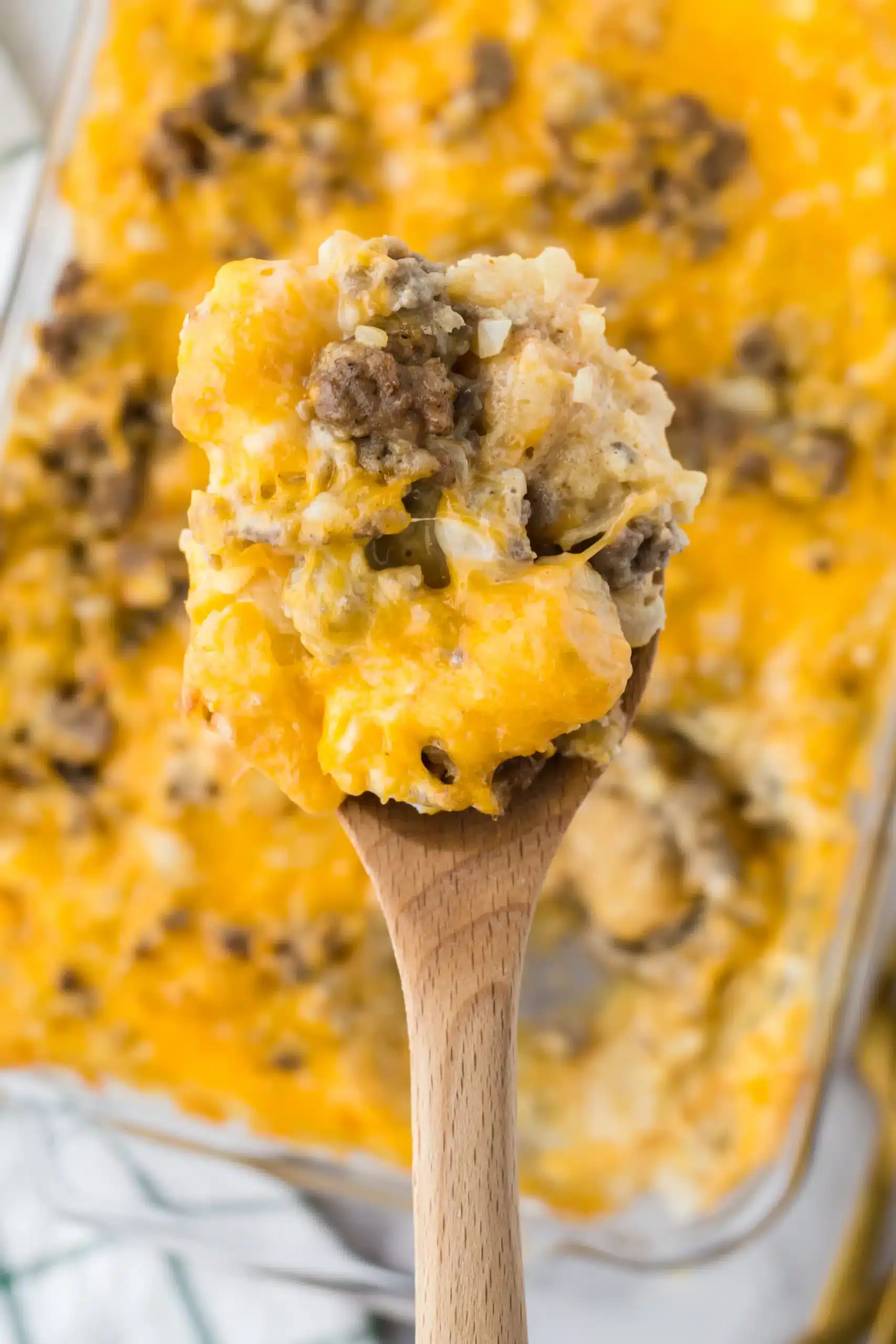 Serving spoon full of tater tot breakfast casserole.