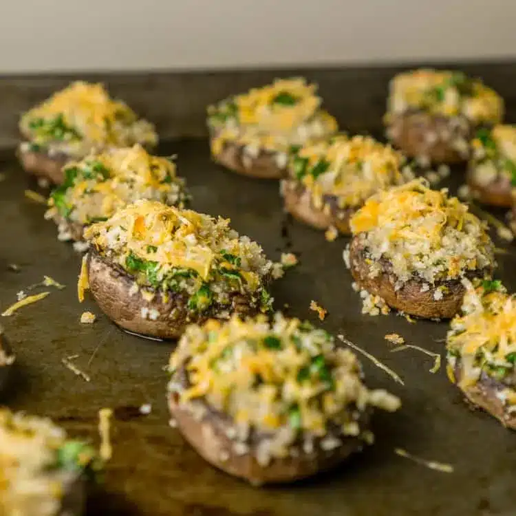 Mimolette stuffed mushrooms on a cookie sheet.