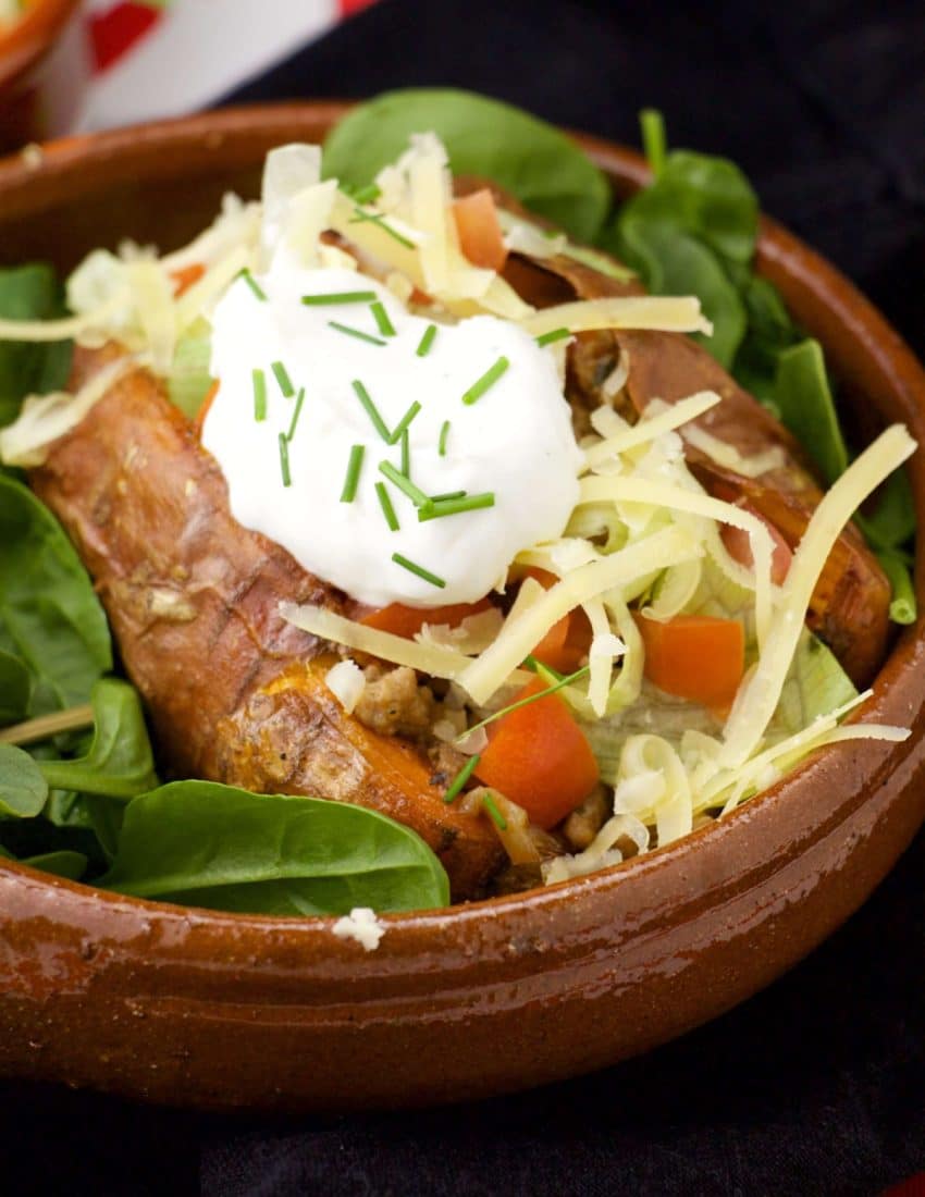 Mexican stuffed sweet potato in a brown bowl.