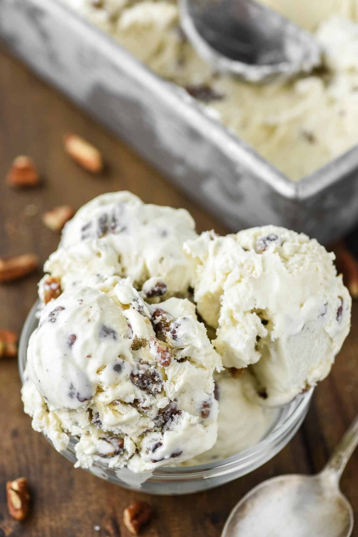 No churn butter pecan ice cream in a clear bowl.