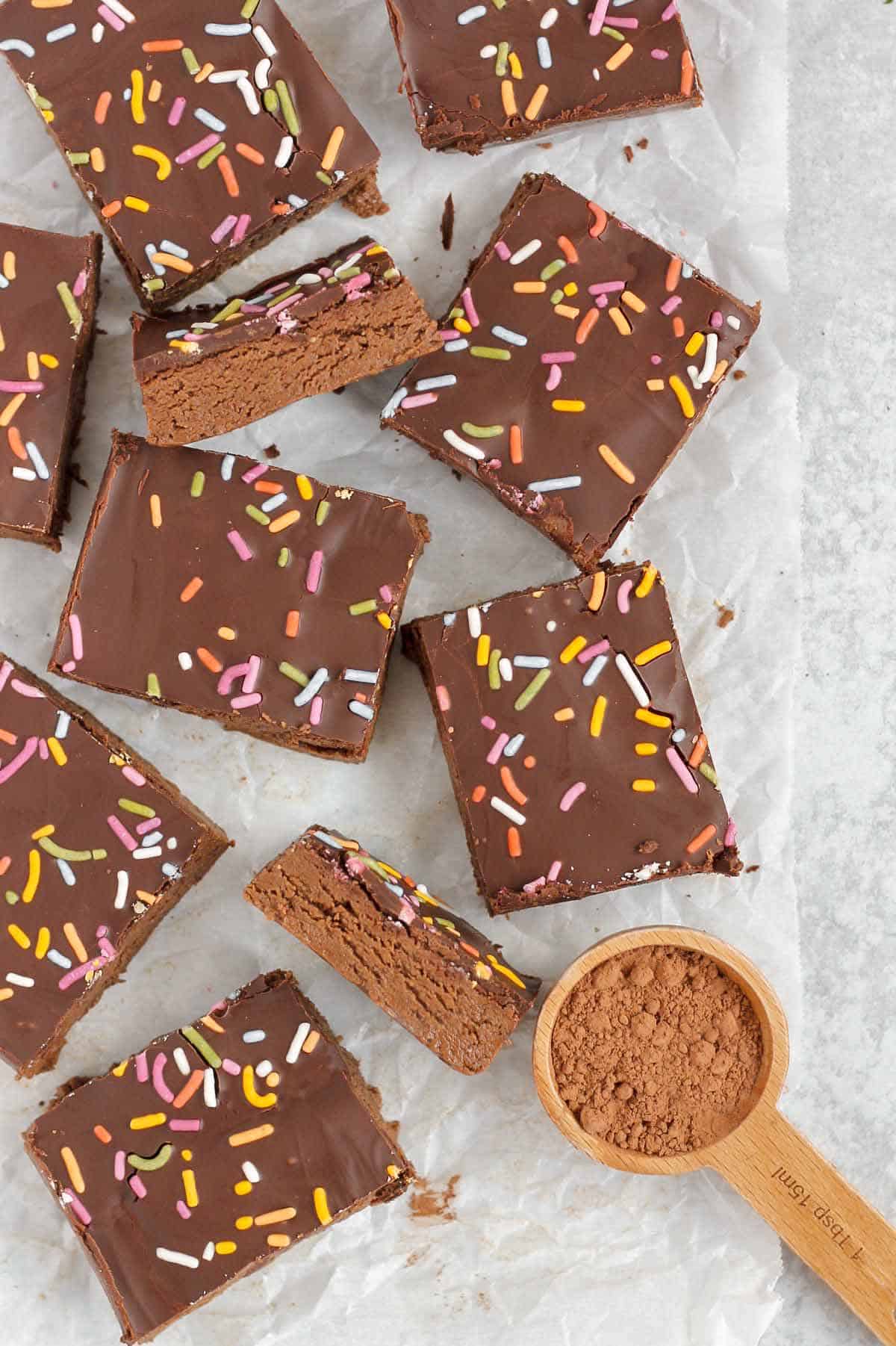 Portioned no bake chocolate protein bars on a parchment paper.