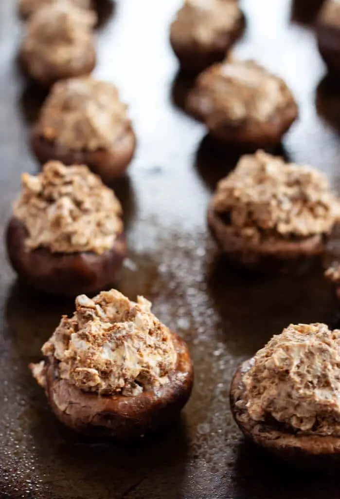 Chorizo stuffed mushrooms on a sheet pan.