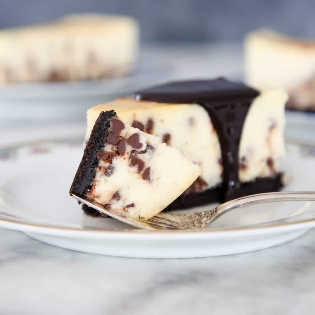 Slice of chocolate chip pie with Oreo crust and chocolate sauce.