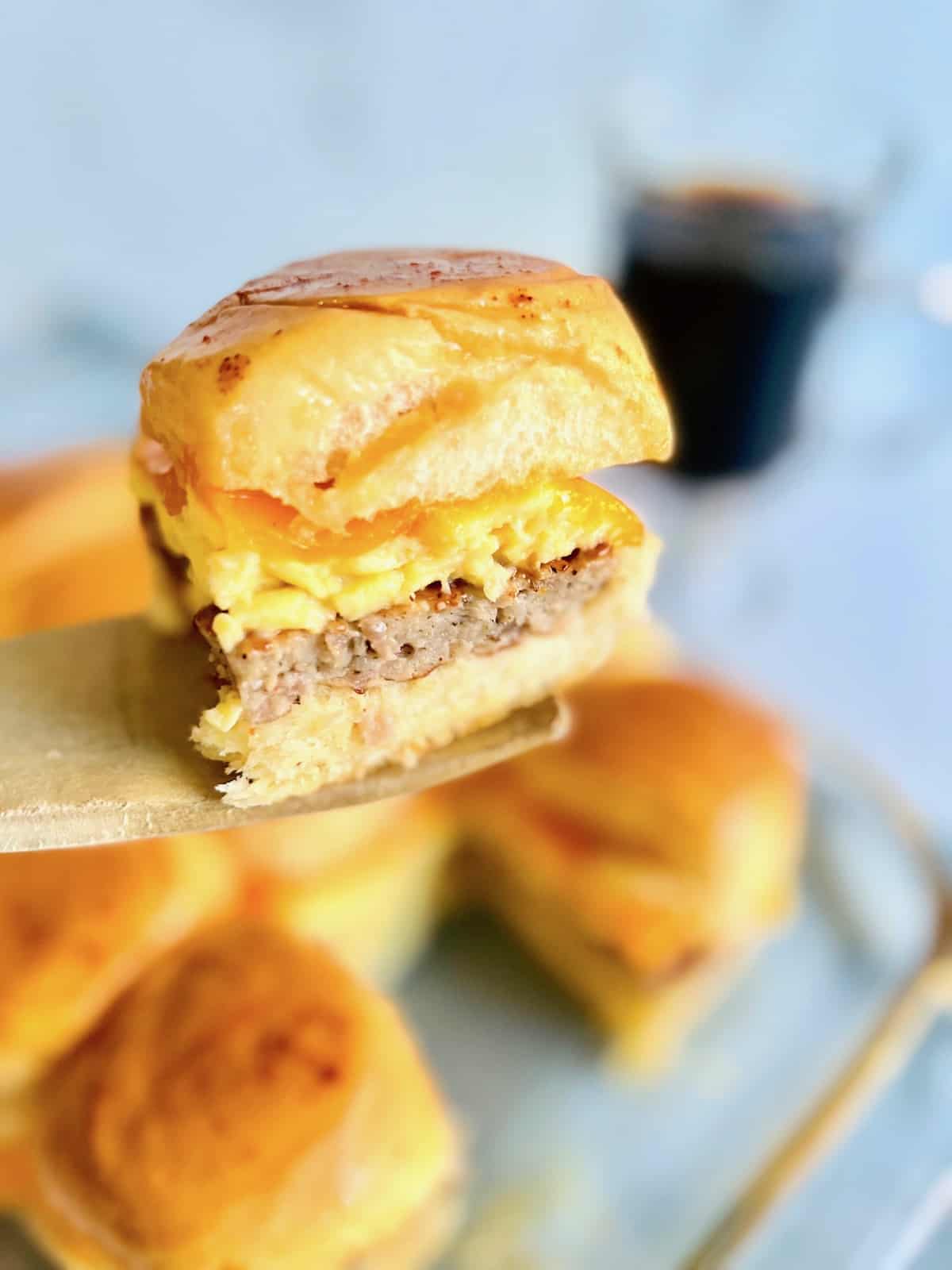 Hawaiian roll breakfast slider on a wooden utensil.