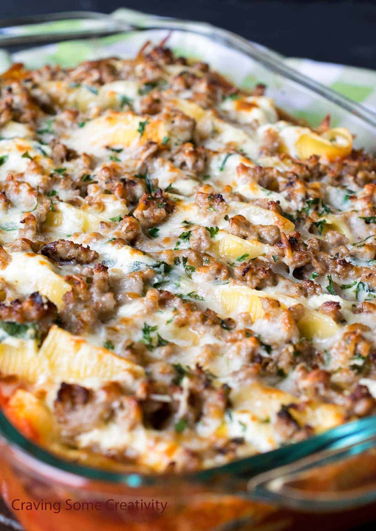 Italian sausage stuffed shells in a clear serving dish.