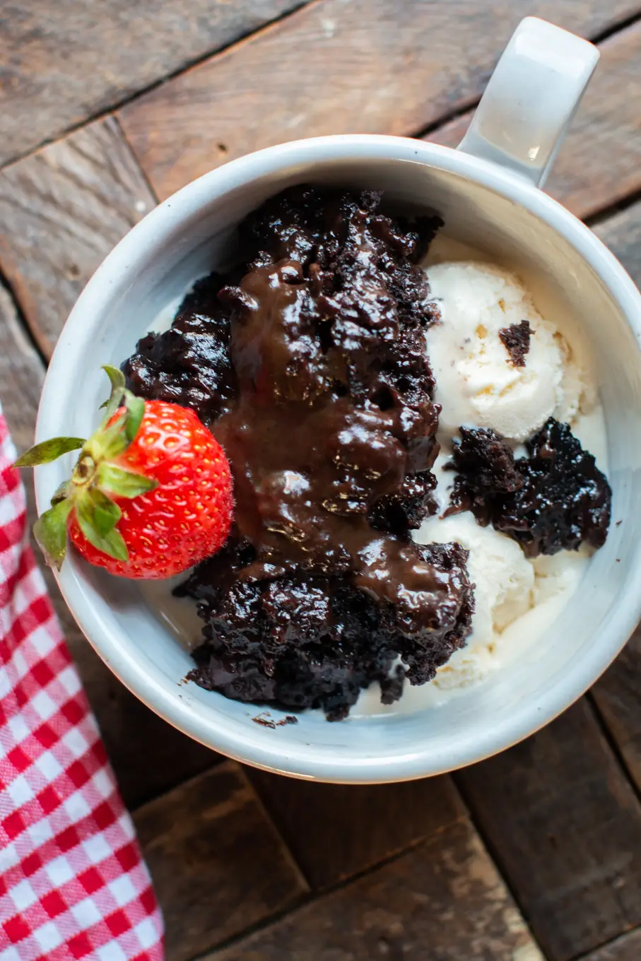 Serving of chocolate lava cake in a mug.