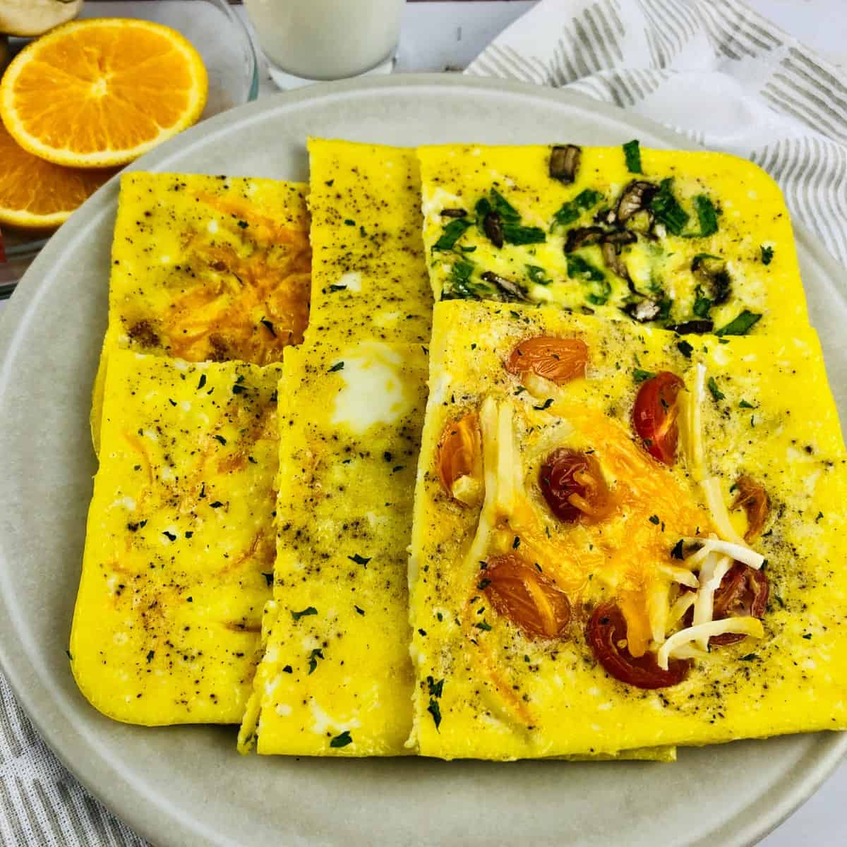 Sheet pan scrambled eggs on gray plate.