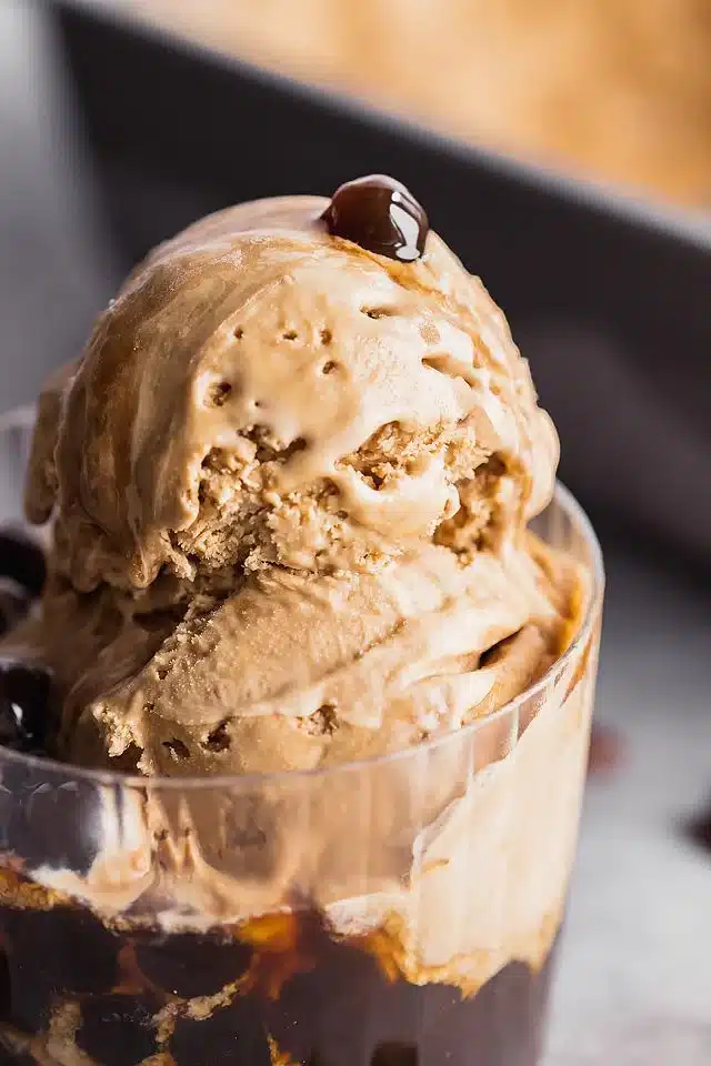 Coffee ice cream with boba in a glass.