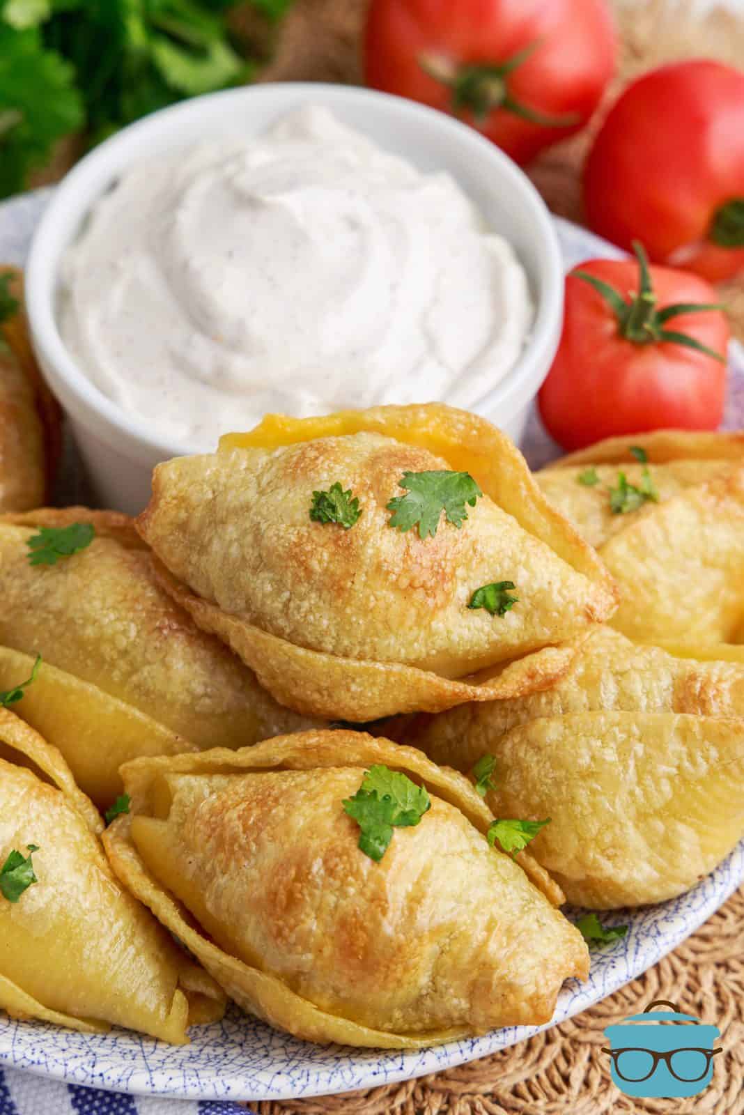 Plate full of air fryer taco stuffed shells with taco seasoned sour cream. 