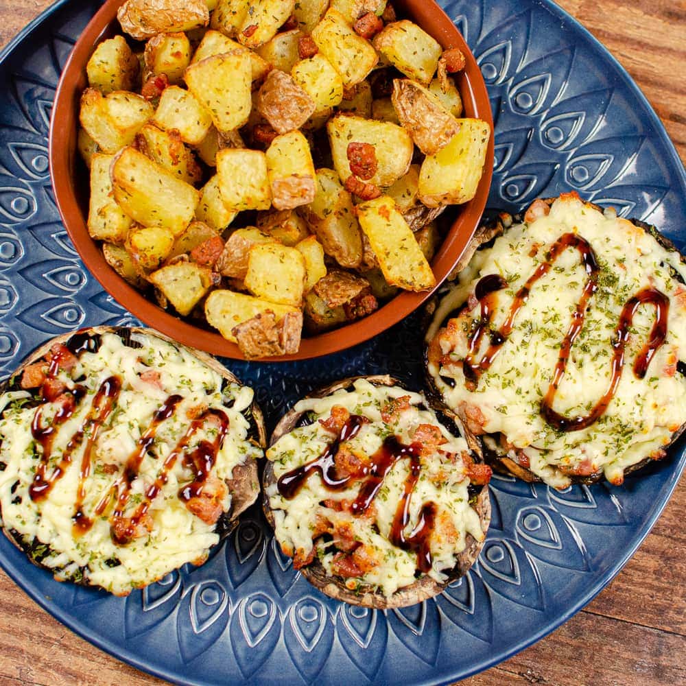 Pancetta and mozzarella mushrooms on a decorative blue plate.