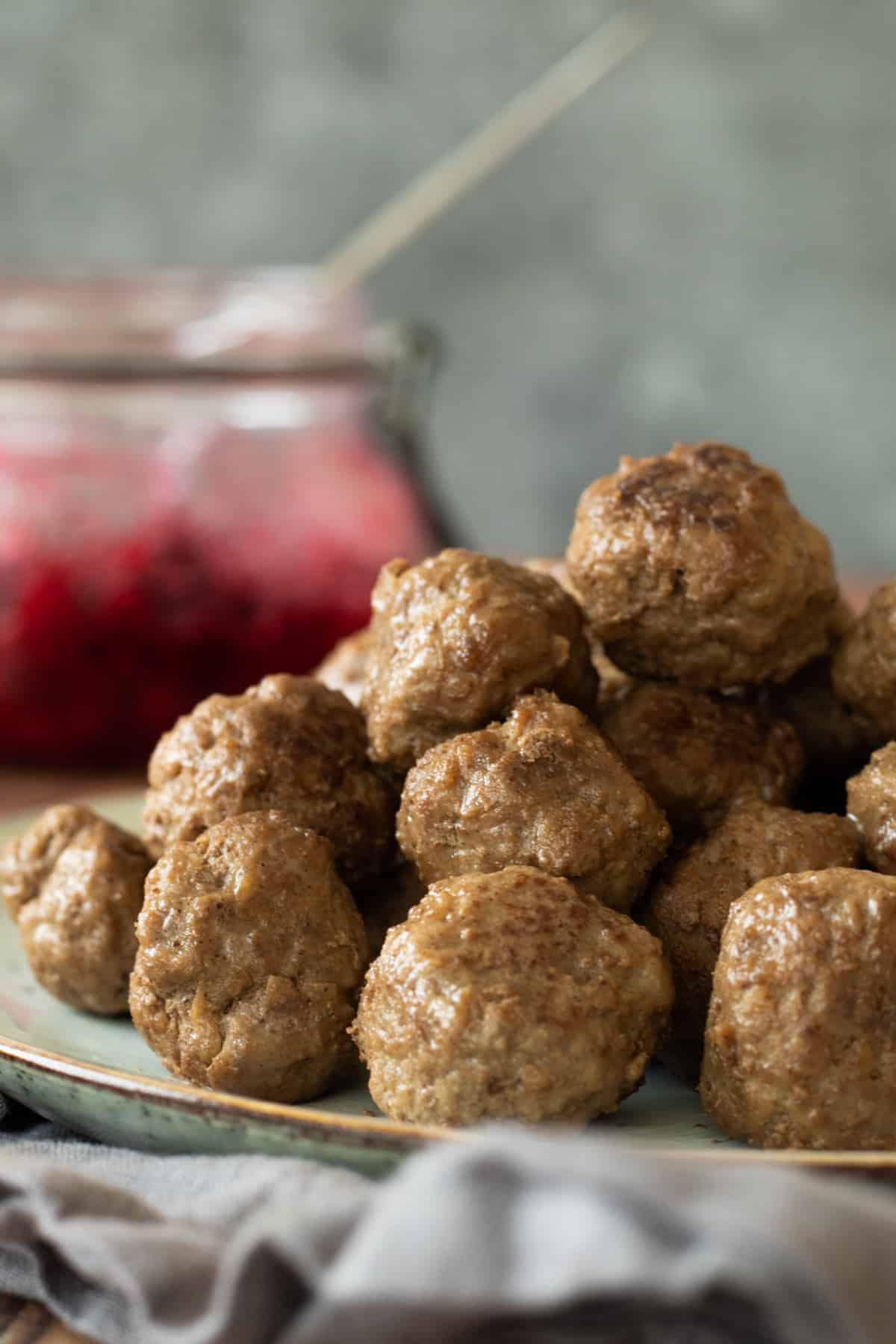 Stack of meatballs on a gray plate.