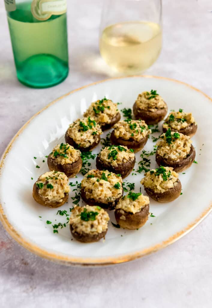 Boursin stuffed mushrooms on a white plate.