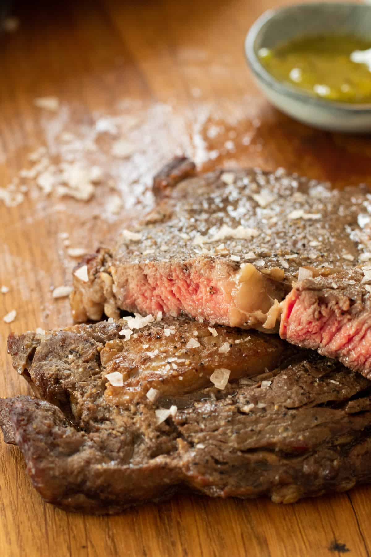 Air fryer ribeye steak on a cutting board.