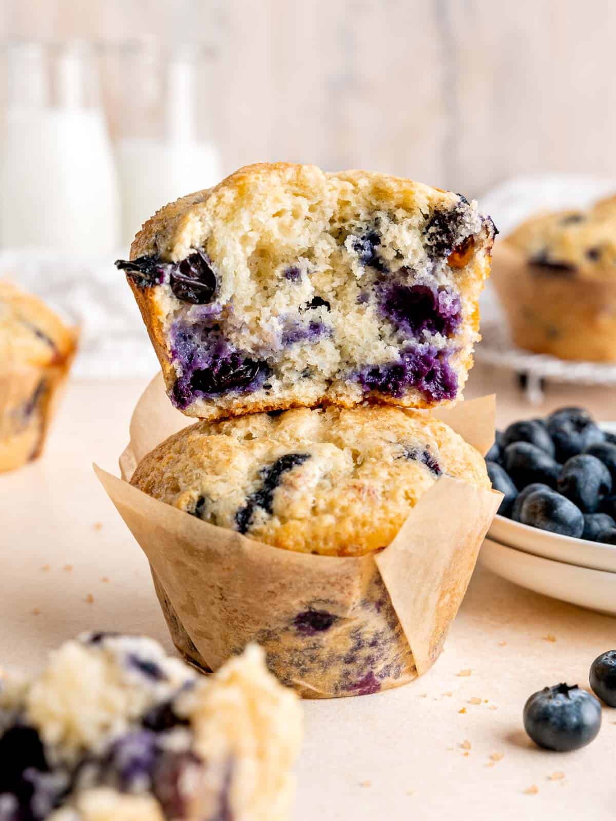 Half eaten sourdough discard jumbo blueberry muffin stacked on top of another one.
