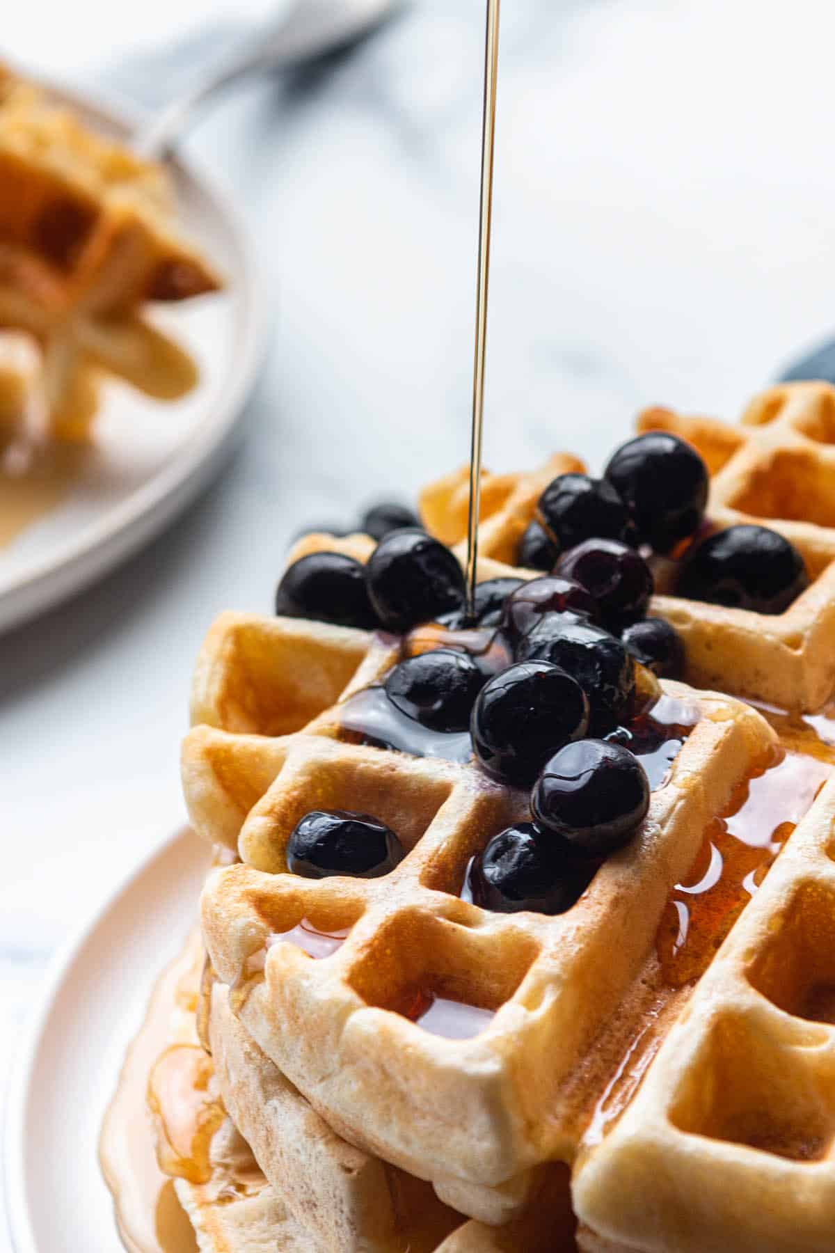 Sourdough discard waffles with syrup drizzled on it.