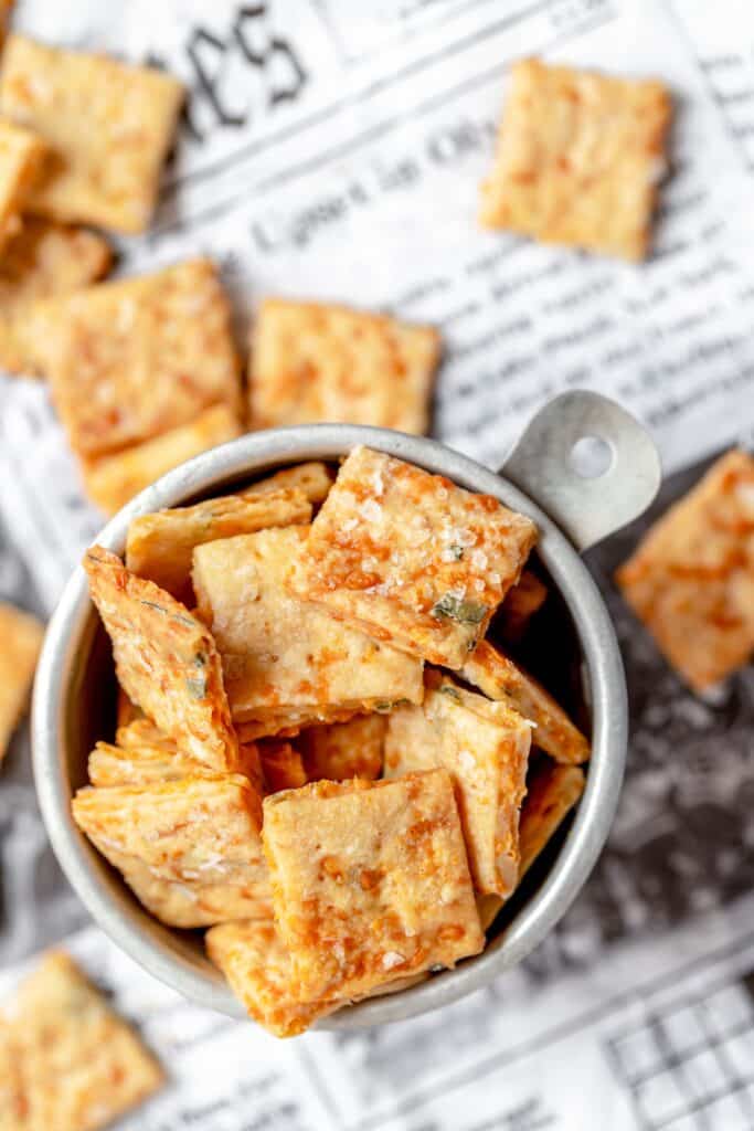 Cheesy sourdough discard crackers in a metal bowl.