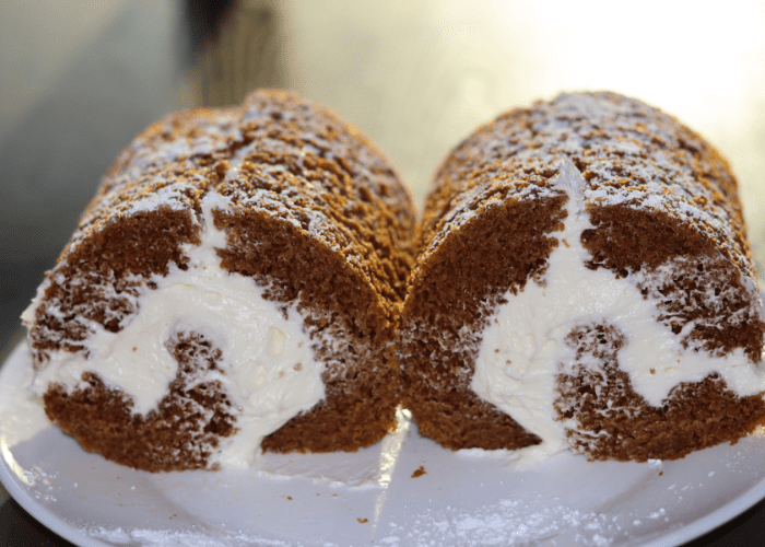 Sourdough pumpkin rolls on a white plate.