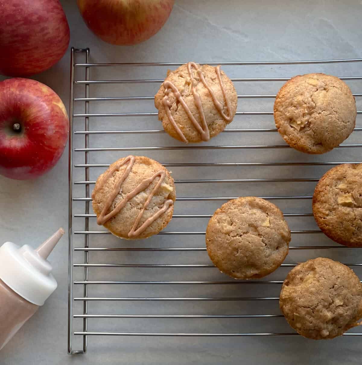 Sourdough apple muffins on a cooling rack.