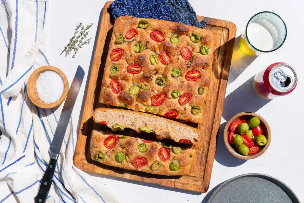 Spelt sourdough focaccia on a cutting board.