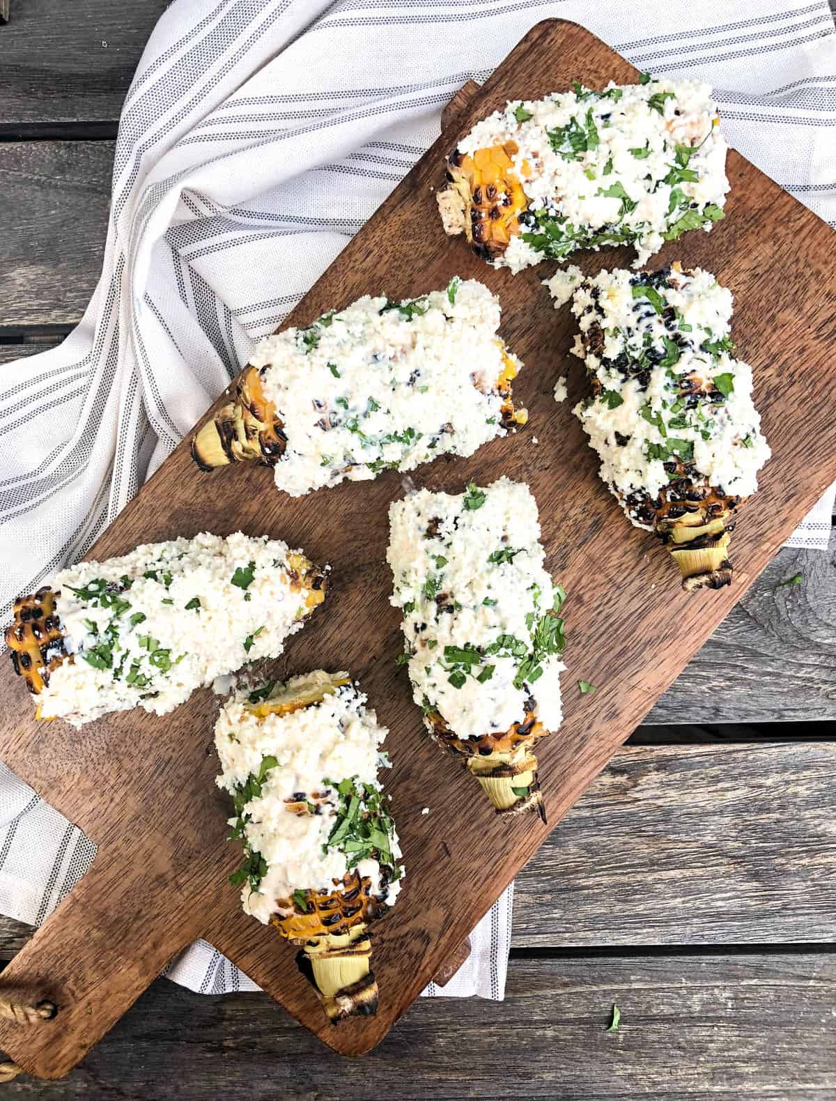 California street corn on a wooden cutting board.