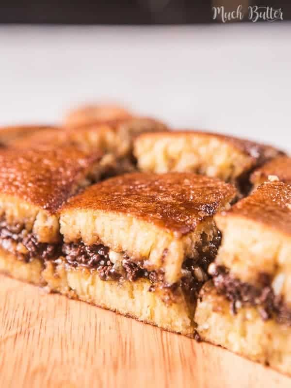 Sliced Indonesian pancake dessert with chocolate and peanuts.