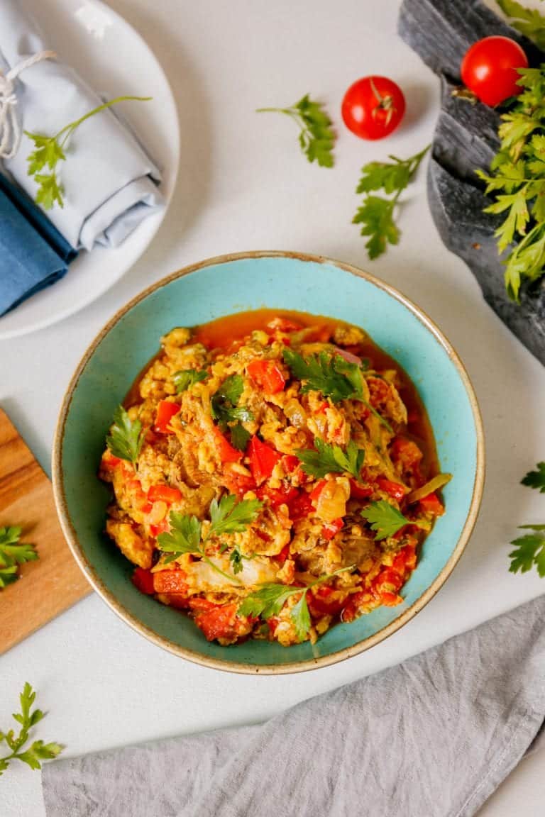 Nigerian egg stew in a decorative blue bowl.