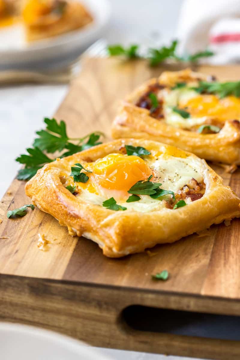 Bacon and egg galette on a wooden board.
