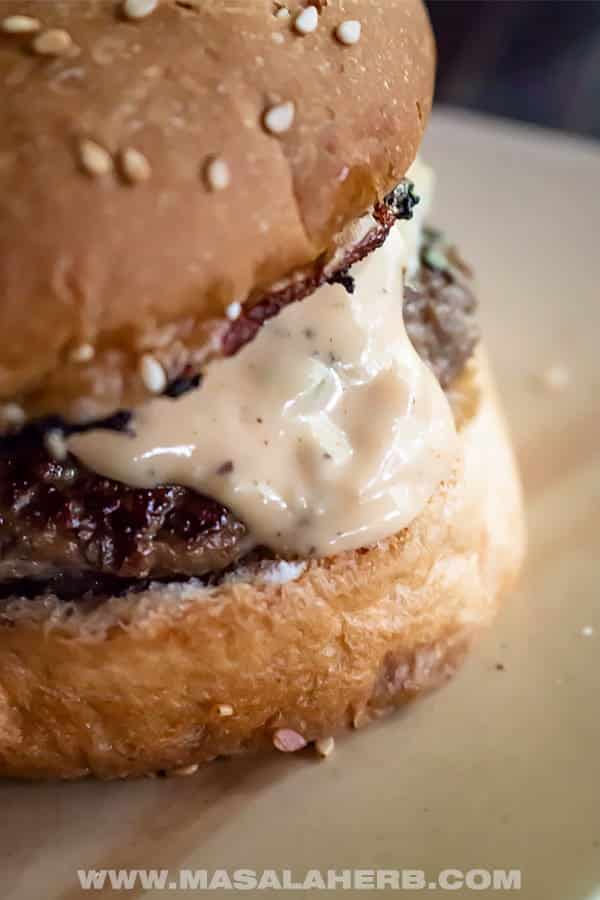 Closeup of burger dripping Big Mac sauce.