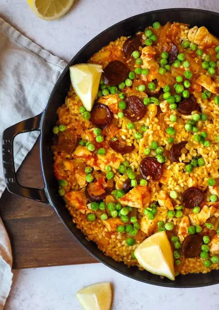 Chicken and chorizo paella in a large cast iron pan.